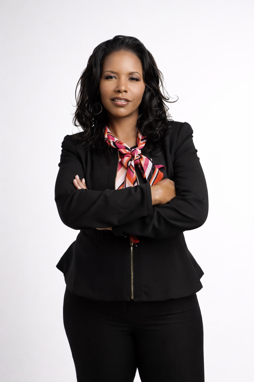 Dr. Sharmee Pratt in a black suit with a colorful scarf