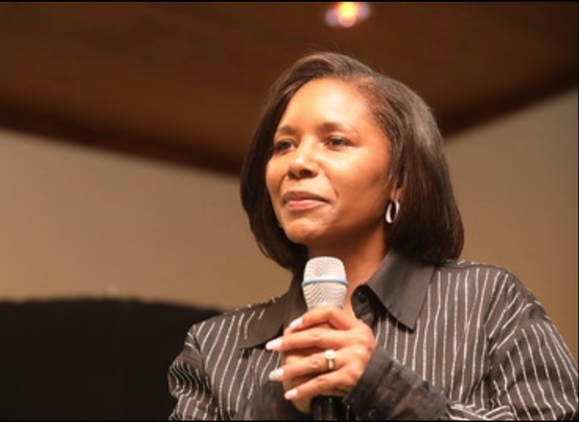 Dr. Sharmee Pratt speaking with a microphone